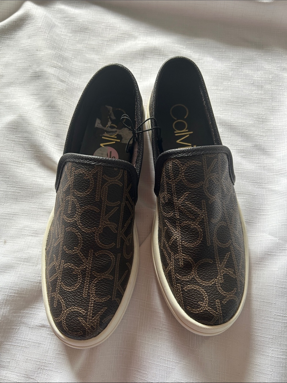 Calvin Klein Brown Monogram Slip-On Sneakers with White Sole have peel inside